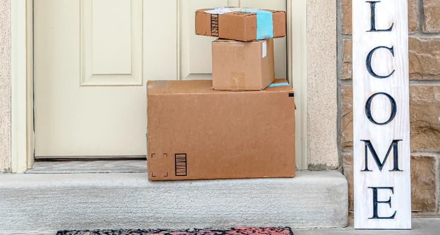 Deliveries on the front porch of a house with a welcome sign in Springfield